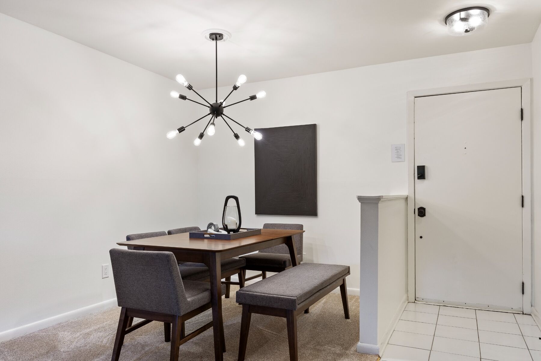 Dining table and entryway in the furnished first-floor condo
