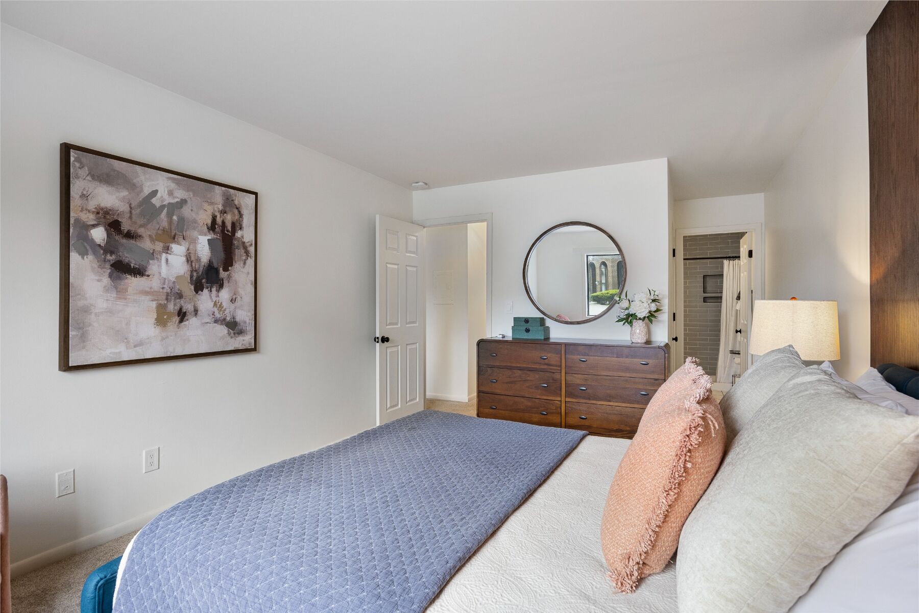 Queen bedroom with dresser and full-length mirror