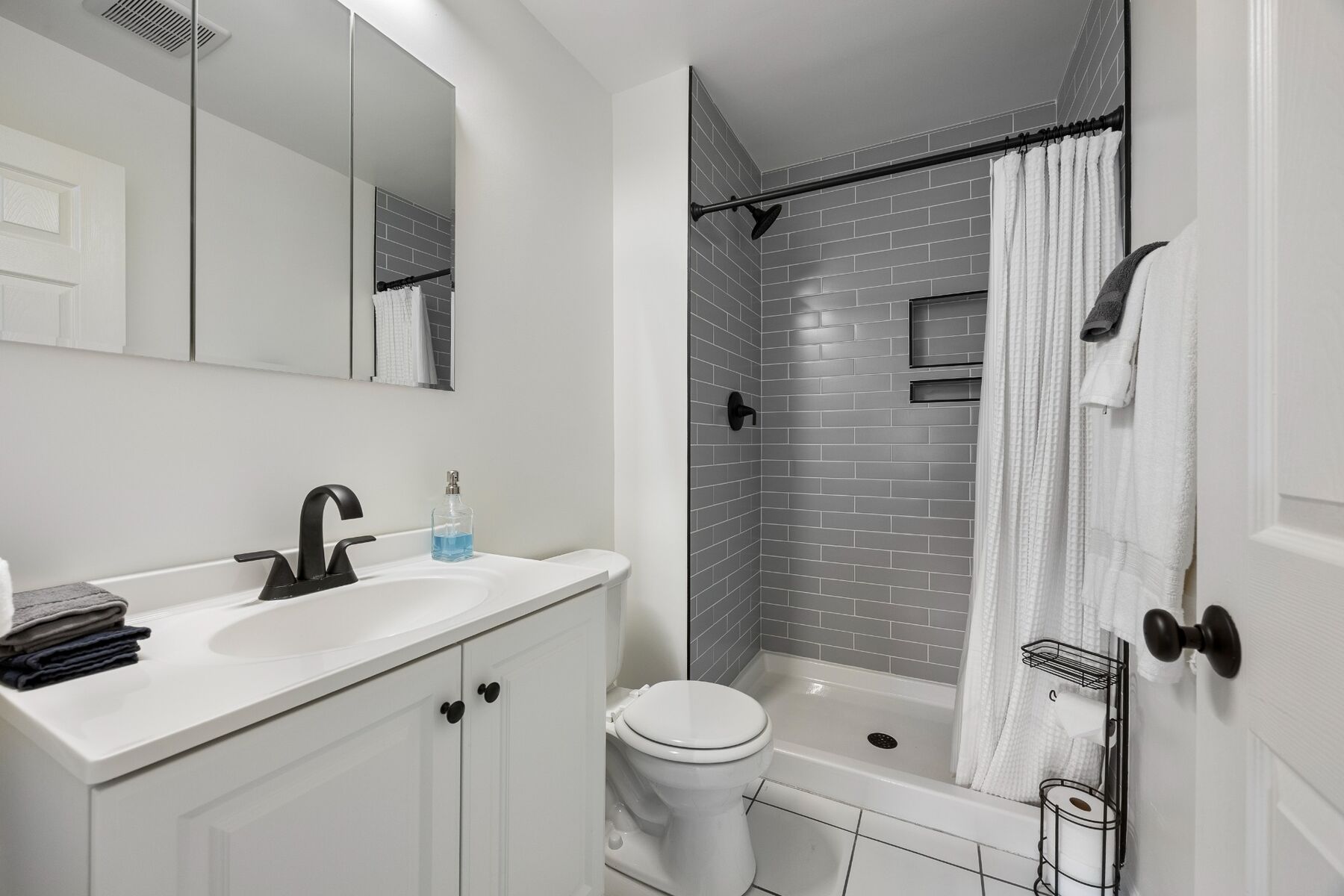 Full bathroom with vanity, toilet, and walk-in shower