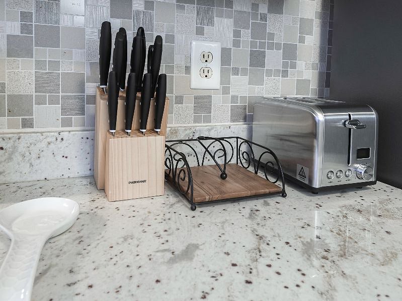 Kitchen counter with knife block, toaster, and cooking utensils