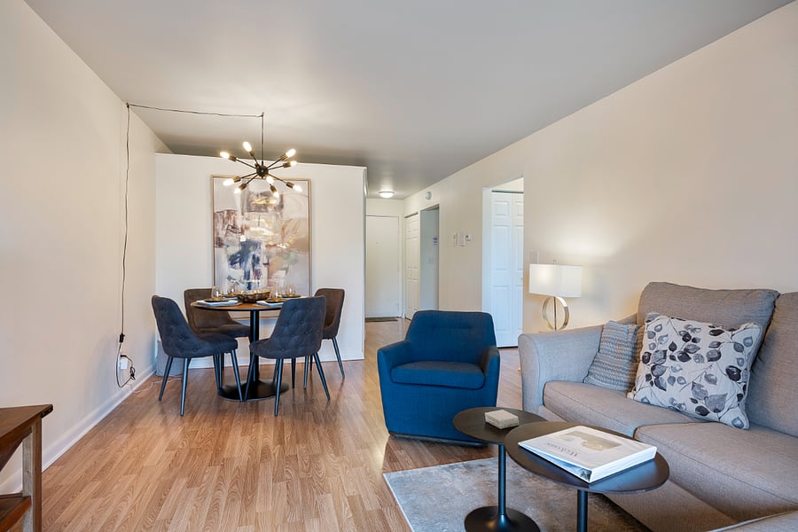 Comfortable living room with sofa, chairs, and dining area