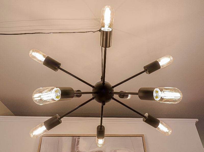 Modern black light fixture above the dining area