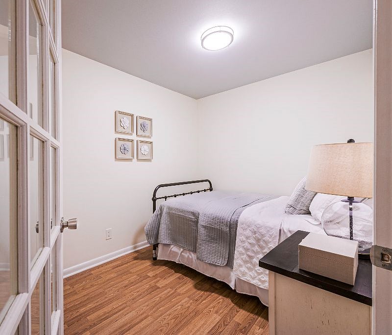 Second bedroom with full bed, lamp, and nightstand